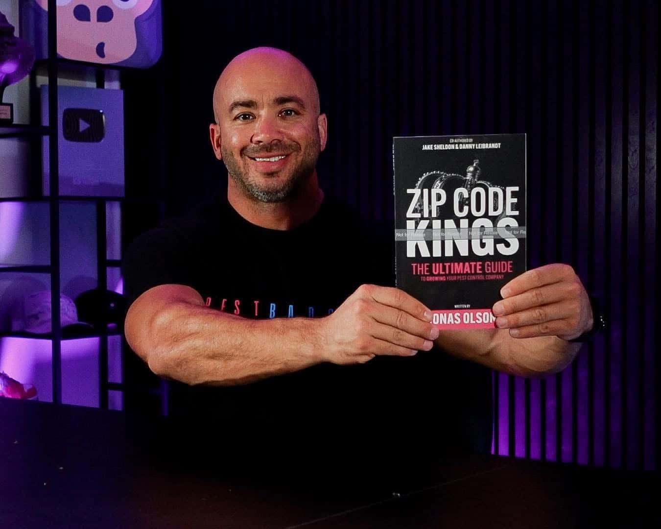 Jonas Olson holding Zip Code Kings book
